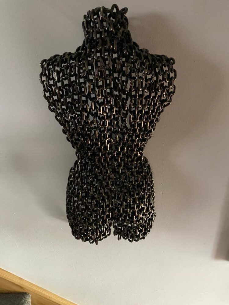 Metal torso sculpture made from welded chain, detail