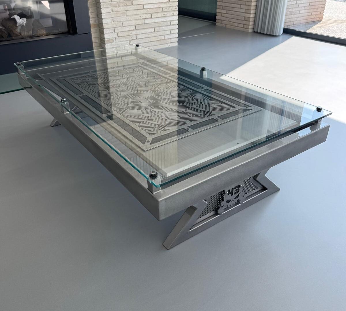 Cut steel coffee table with a glass top
