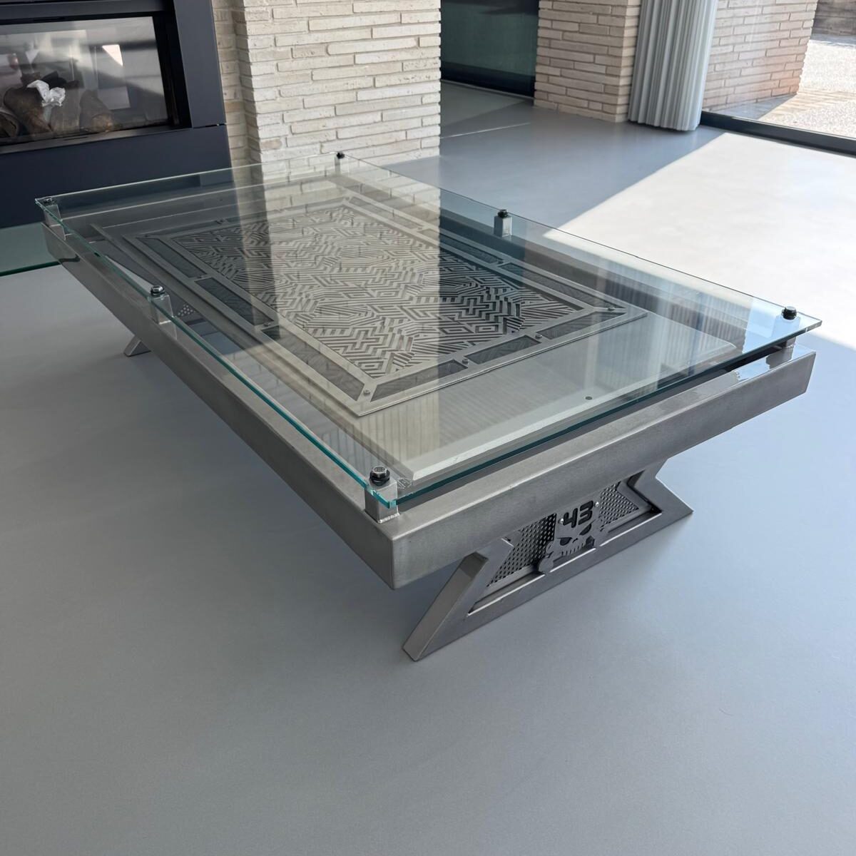 Cut steel coffee table with a glass top