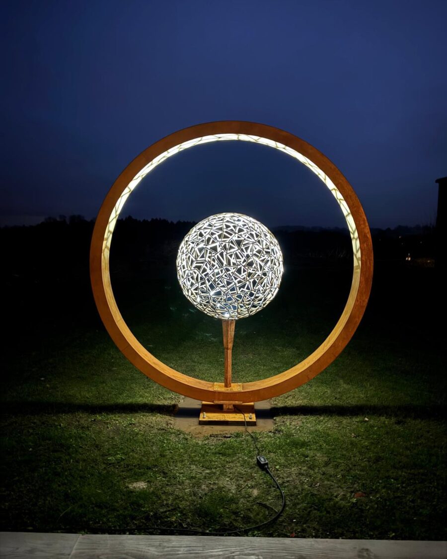 Moon gate illuminated at night with a glowing sphere