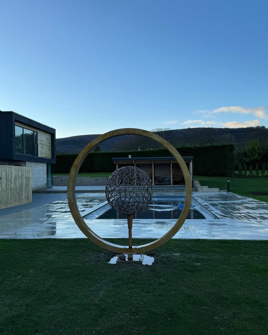 Moon gate by the pool with the house behind